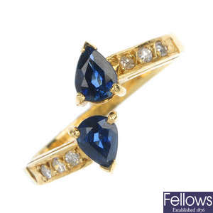 A sapphire and diamond two-stone crossover ring. 