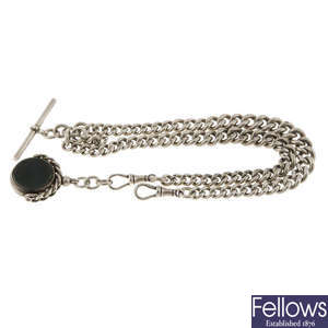 A pocket watch chain and fob together with two other pocket watch chains.   