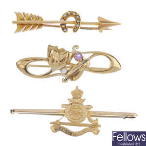 A group of four 9ct gold brooches.