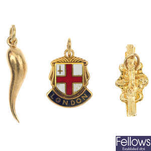A selection of nine 9ct gold charms and a crown charm.