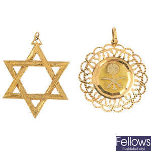 A selection of three religious pendants.