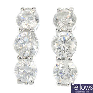 A pair of 9ct gold diamond three-stone ear studs.