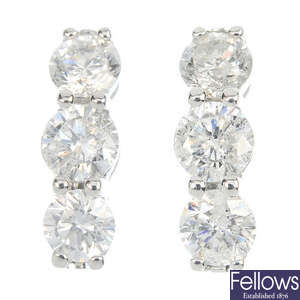 A pair of 9ct gold diamond three-stone ear studs.