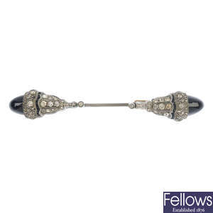 An early 20th century silver onyx and paste jabot pin.