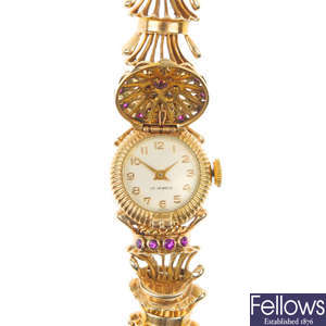 A lady's 1950s 9ct gold diamond and synthetic ruby manual wind bracelet watch.