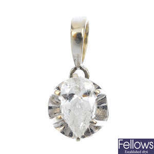 A pear-shape diamond single-stone pendant.