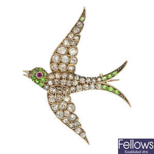An early 20th century gold diamond and gem-set bird brooch.