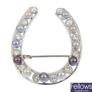 A diamond and cultured pearl horseshoe brooch.