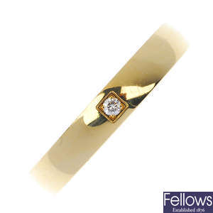 OMEGA - an 18ct gold diamond single-stone band ring.