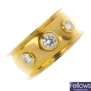 A 1970's 22ct gold diamond three-stone band ring.