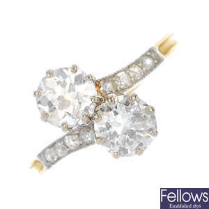 A mid 20th century platinum and gold diamond two-stone crossover ring.