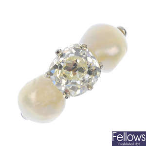A diamond and natural pearl three-stone ring.