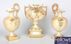 A Royal Worcester blush ivory porcelain matched garniture of vases