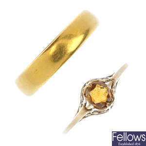 A mid 20th century 22ct gold band ring and a citrine ring. 