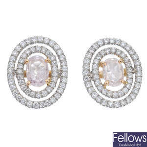 A pair of 'pink' diamond and diamond cluster ear studs. 