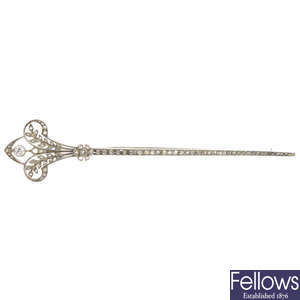 A diamond stylised fleur-de-lys pin brooch.