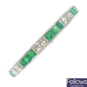 An emerald and diamond full-circle eternity ring.