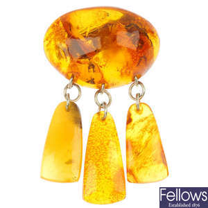 A tagua nut carved pendant and two items of reconstituted amber.