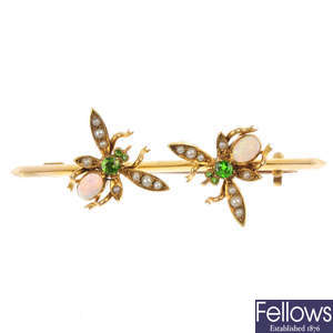 An early 20th century gold opal, split pearl and demantoid garnet insect brooch.