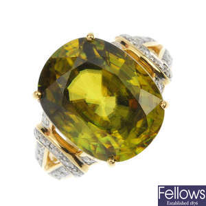 An 18ct gold sphene and diamond single-stone ring. 