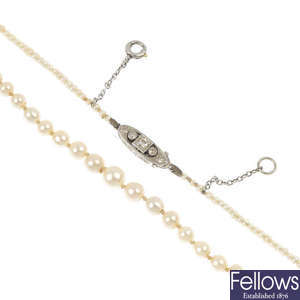 An early 20th century natural pearl single-strand necklace with diamond clasp.