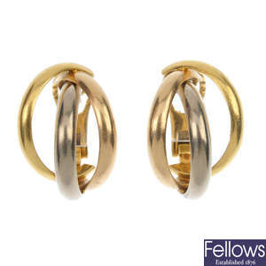 CARTIER - a pair of 18ct gold 'Trinity' ear hoops. 