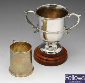 A silver christening mug, trophy cup, etc.