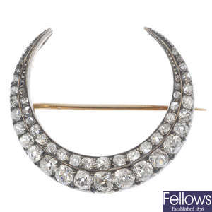 A late 19th century 12ct gold and silver diamond crescent brooch.