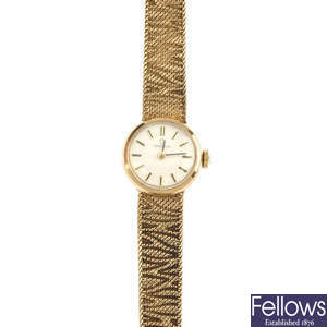 OMEGA - a lady's 1960s 9ct gold wrist watch.