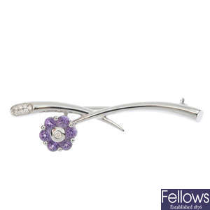 An amethyst and diamond floral brooch.