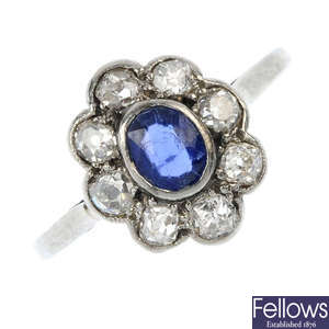 An early 20th century platinum and 18ct gold sapphire and diamond floral cluster ring.