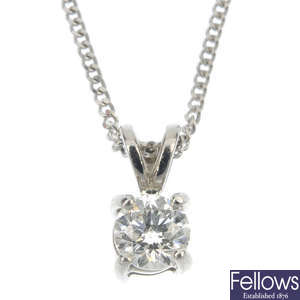 A platinum diamond single-stone pendant. 