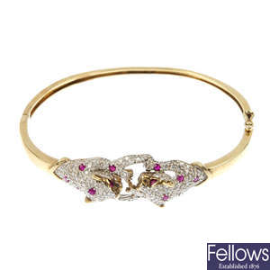 A 9ct gold diamond and ruby leopard bangle.
