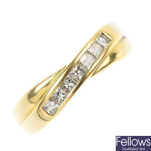 An 18ct gold diamond half-circle crossover eternity ring.