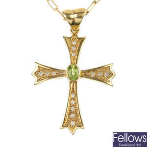 A peridot and diamond cross pendant. 