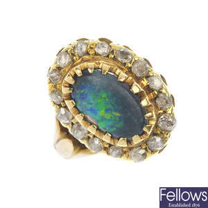 An early 20th century 18ct gold black opal and diamond cluster ring. AF.