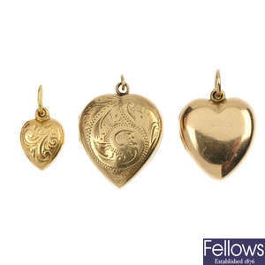 Two 9ct gold heart-shape lockets and a pendant.