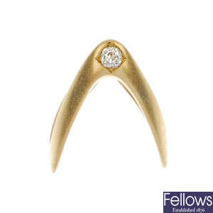 An early 20th century 18ct gold diamond single-stone chevron ring.