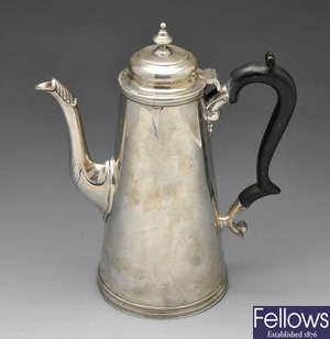 A late Victorian silver coffee pot with engraved armorial.