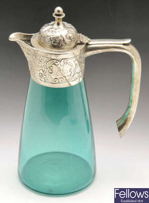 A late Victorian silver mounted green glass jug.