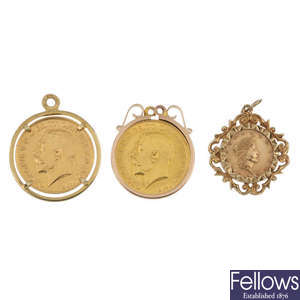 A selection of three coin pendants.
