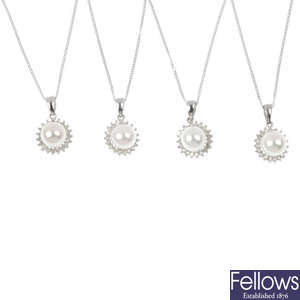 A selection of four 9ct gold cultured pearl and diamond cluster pendants. 