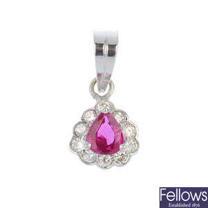 A ruby and diamond cluster pendant.