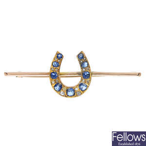 A sapphire and diamond horseshoe bar brooch.