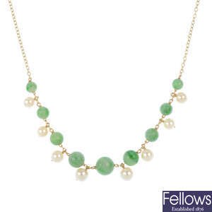 A jade and cultured pearl necklace and a jade ring.