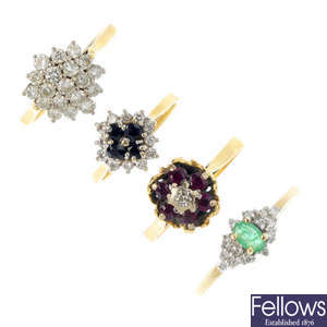 A selection of four gold gem-set rings.