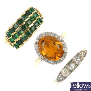 A selection of three 18ct gold gem-set rings.