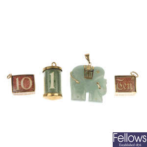 A jade elephant pendant and three 9ct gold note charms.