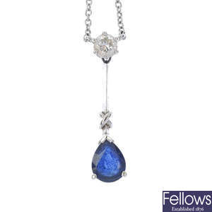 A platinum sapphire and diamond pendant and earring set.