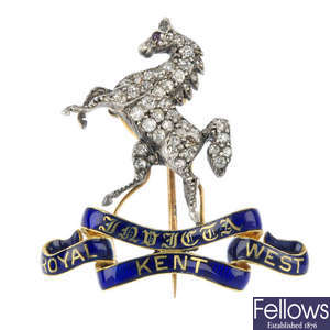An early 20th century silver and 18ct gold diamond and enamel regimental brooch.
